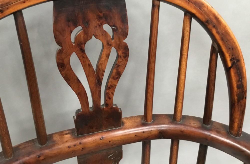 A pair of 19th-century hoop-back Windsor armchairs with pierced central splats, turned legs, curved stretchers, and richly patinated timber. View IV
