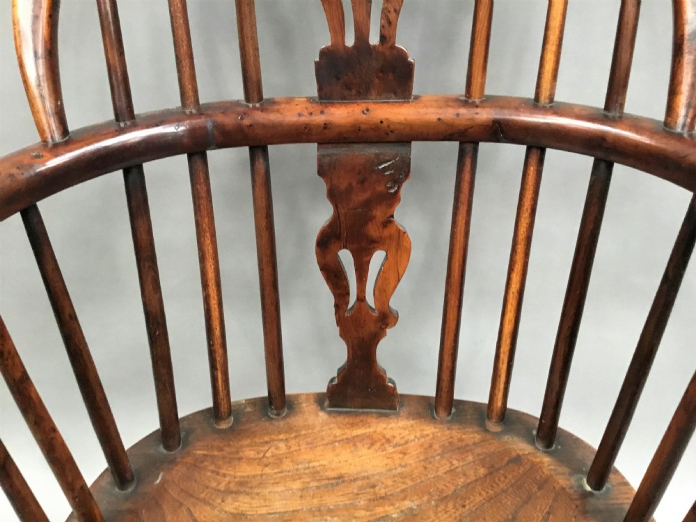 A pair of 19th-century hoop-back Windsor armchairs with pierced central splats, turned legs, curved stretchers, and richly patinated timber. View VI
