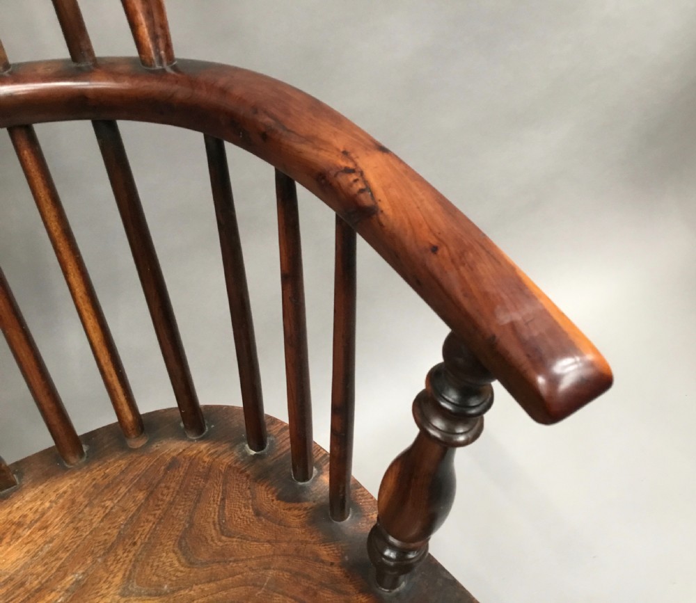 A pair of 19th-century hoop-back Windsor armchairs with pierced central splats, turned legs, curved stretchers, and richly patinated timber. View VII
