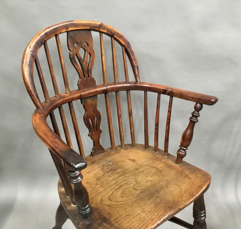A pair of 19th-century hoop-back Windsor armchairs with pierced central splats, turned legs, curved stretchers, and richly patinated timber. View XI