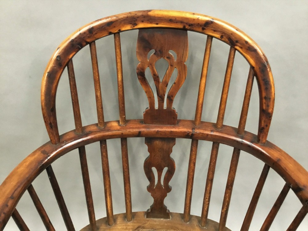A pair of 19th-century hoop-back Windsor armchairs with pierced central splats, turned legs, curved stretchers, and richly patinated timber. View XIII