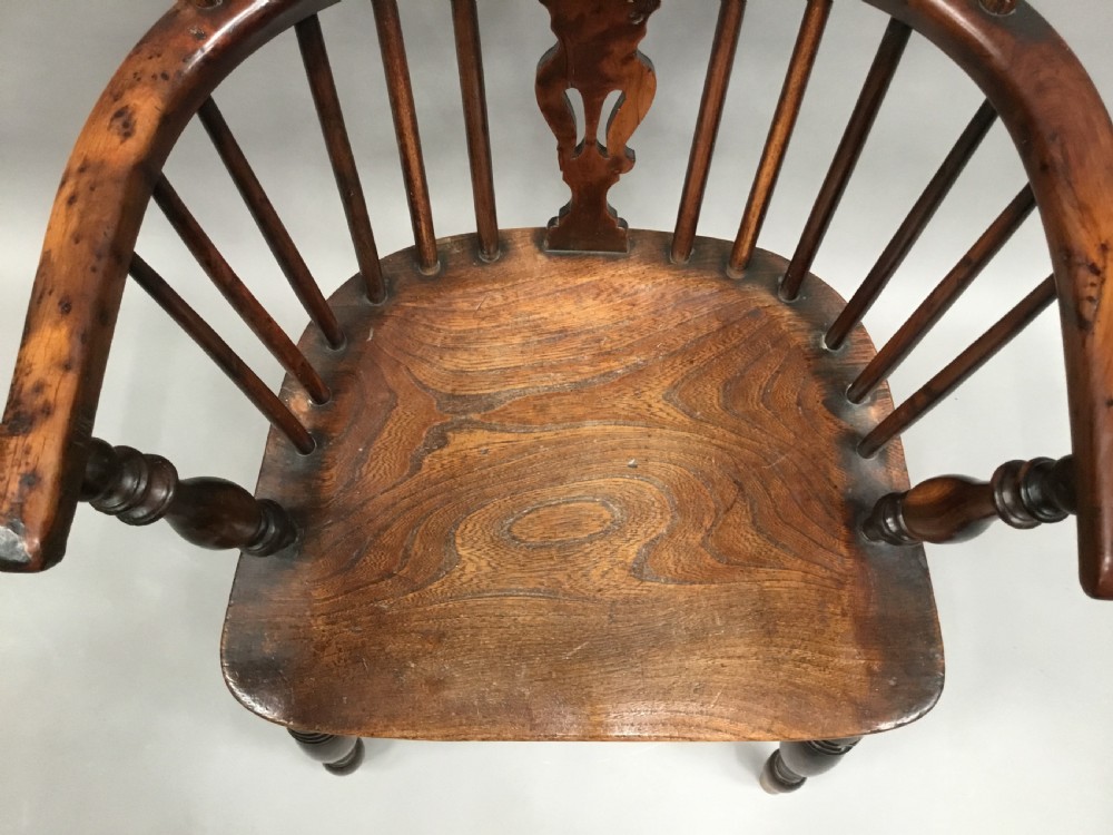 A pair of 19th-century hoop-back Windsor armchairs with pierced central splats, turned legs, curved stretchers, and richly patinated timber. View XV