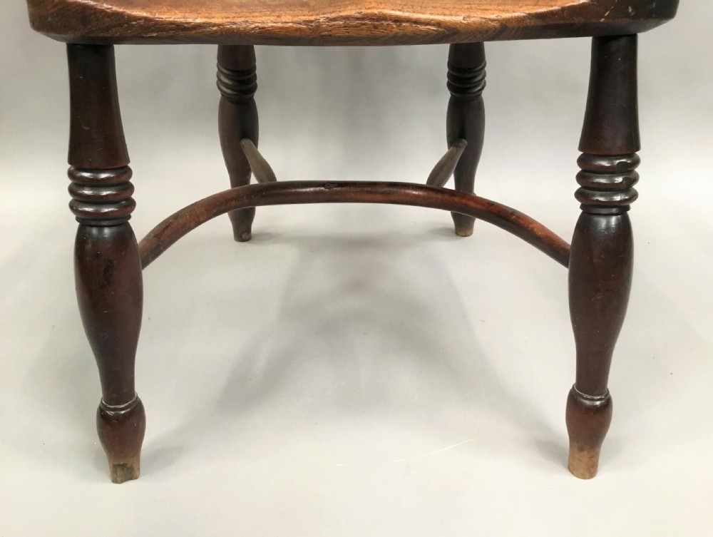 A pair of 19th-century hoop-back Windsor armchairs with pierced central splats, turned legs, curved stretchers, and richly patinated timber. View XVI