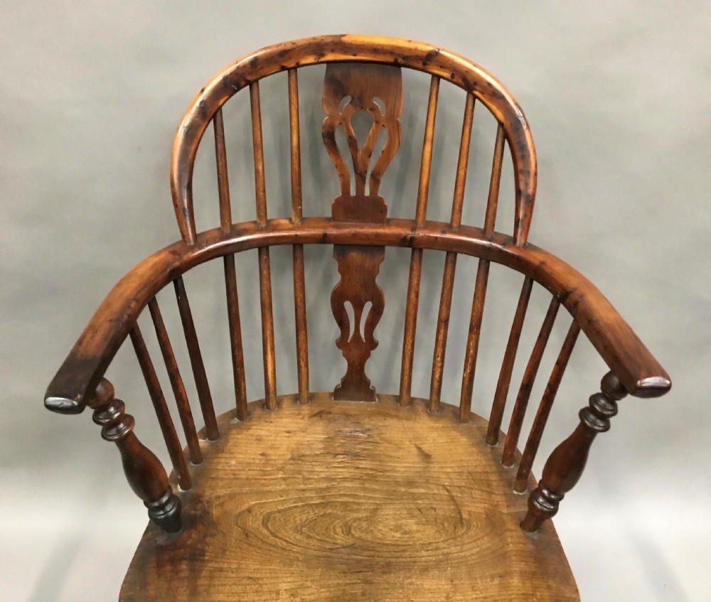 A pair of 19th-century hoop-back Windsor armchairs with pierced central splats, turned legs, curved stretchers, and richly patinated timber. View XVII