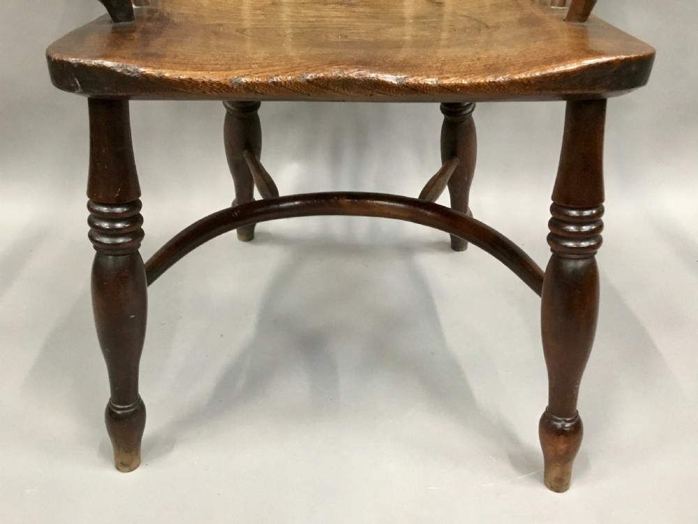 A pair of 19th-century hoop-back Windsor armchairs with pierced central splats, turned legs, curved stretchers, and richly patinated timber. View XVIII