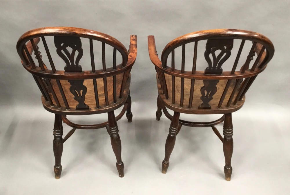 A pair of 19th-century hoop-back Windsor armchairs with pierced central splats, turned legs, curved stretchers, and richly patinated timber. View XIX