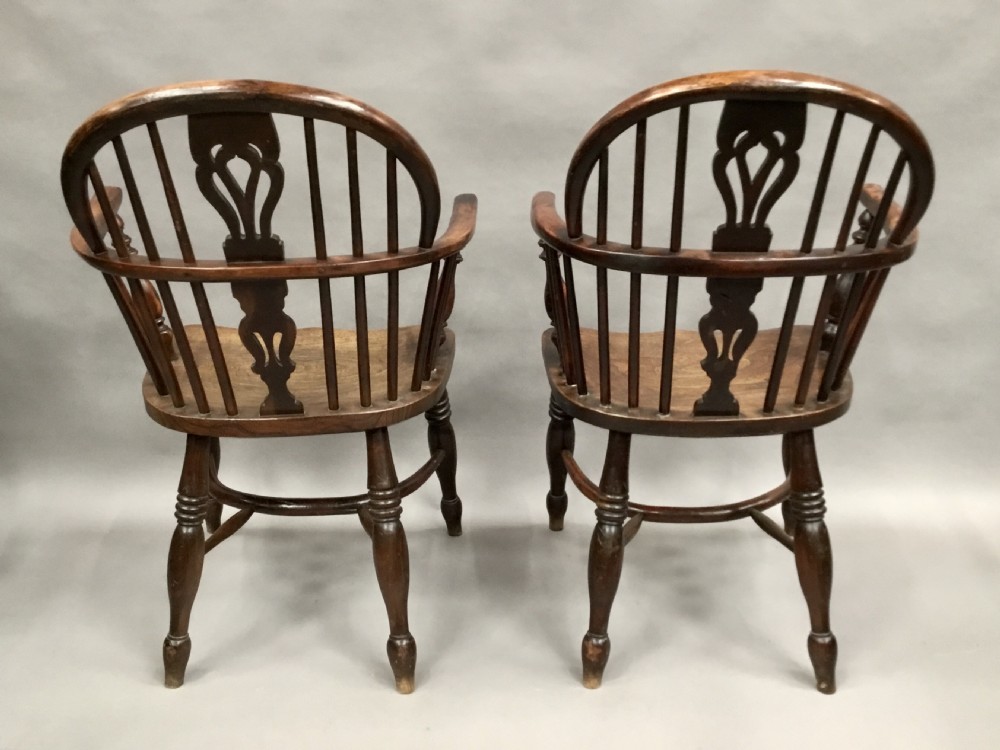 A pair of 19th-century hoop-back Windsor armchairs with pierced central splats, turned legs, curved stretchers, and richly patinated timber. View XXI