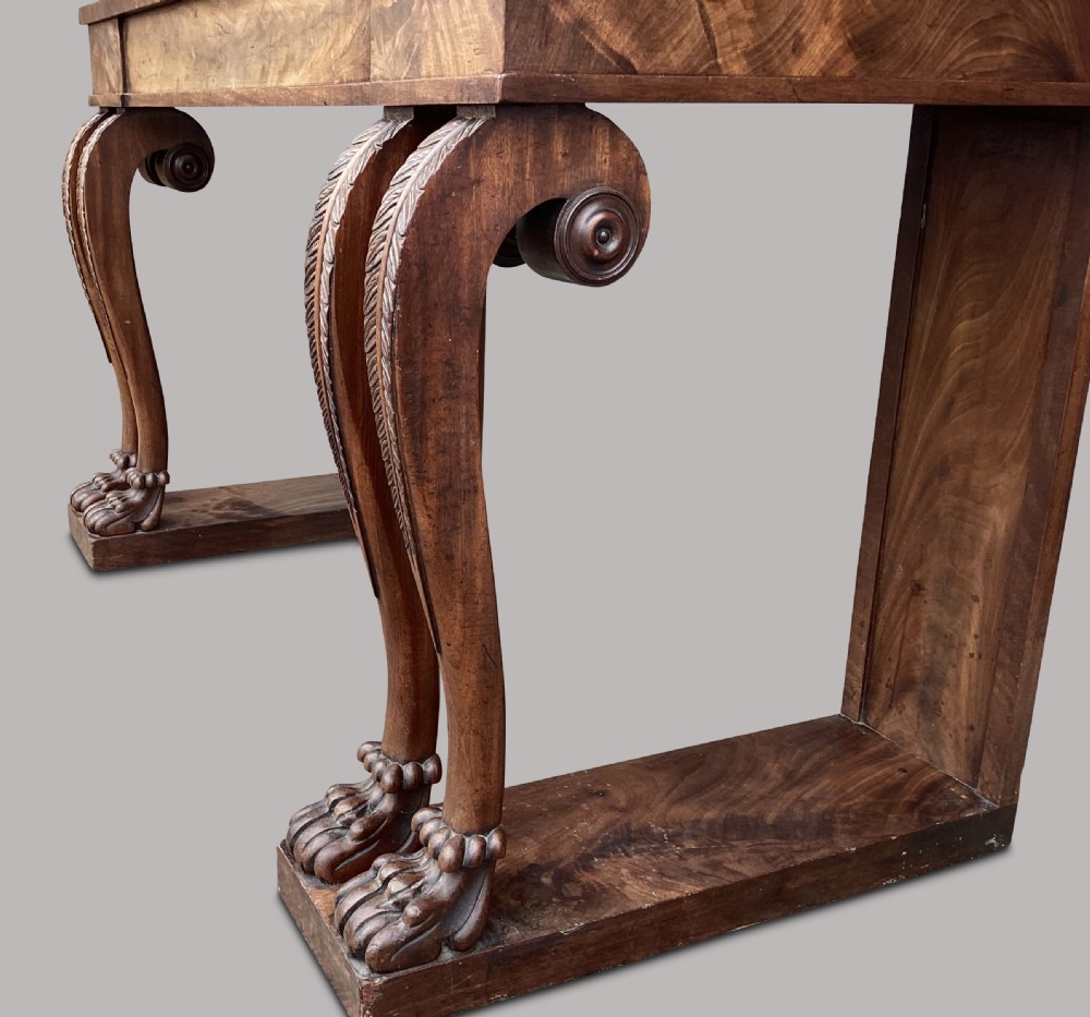 A Regency flame mahogany serving table featuring carved monopodial legs with paw feet and a decorative scrolled cresting rail. View XIX