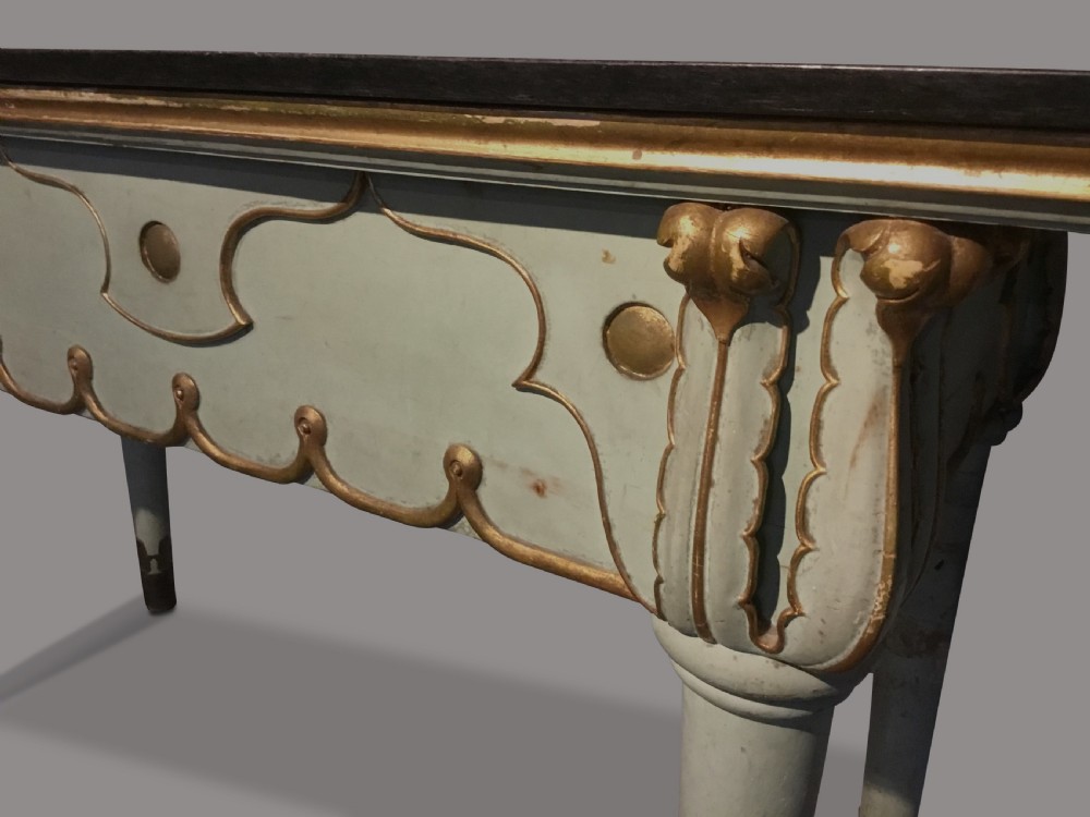 A 19th-century Italian painted side table with a dark top, sage green frame, turned tapering legs, and gilded scalloped apron details. View VI
