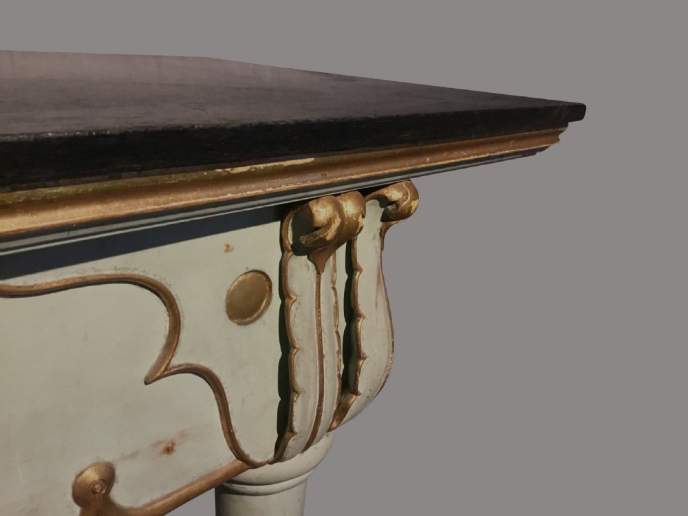 A 19th-century Italian painted side table with a dark top, sage green frame, turned tapering legs, and gilded scalloped apron details. View VII