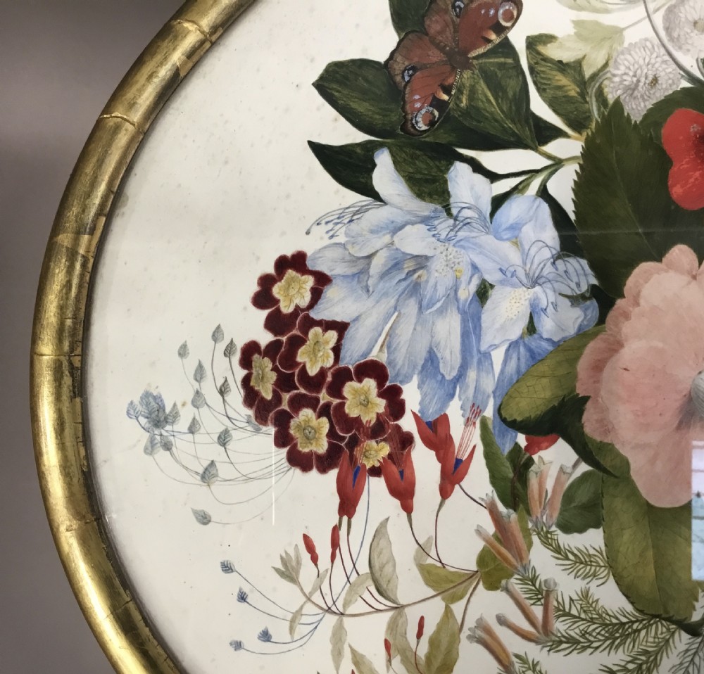An oval Regency occasional table featuring a hand-painted floral arrangement on the top with a gilt rim, resting on a reeded pedestal stem and carved scroll legs. View XIV