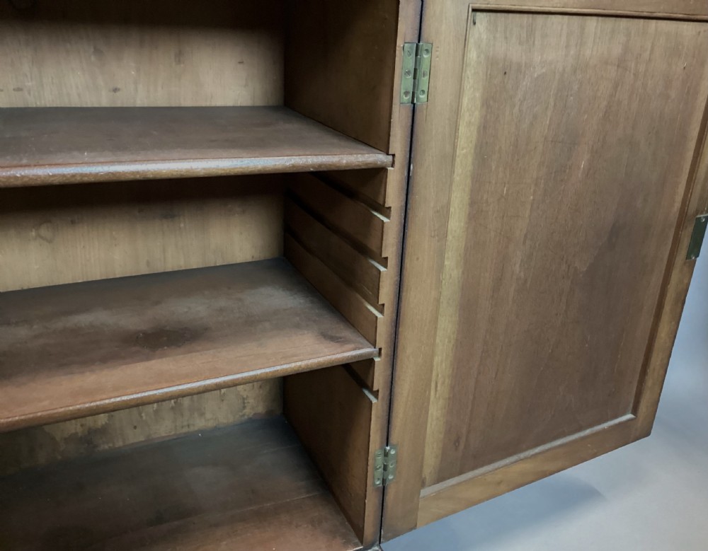 A Regency rosewood side cabinet featuring two panelled doors with brass corner mounts, set beneath a white marble top. View VIII