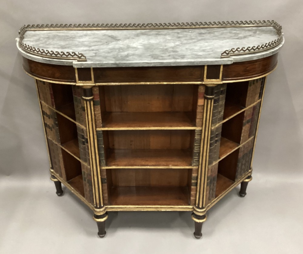 A Regency rosewood breakfront open cabinet featuring a marble top with a brass gallery, central open shelves flanked by faux leather book spines, and fluted gilt columns on tapered legs. View XIV