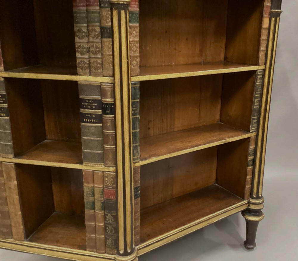 A Regency rosewood breakfront open cabinet featuring a marble top with a brass gallery, central open shelves flanked by faux leather book spines, and fluted gilt columns on tapered legs. View XV