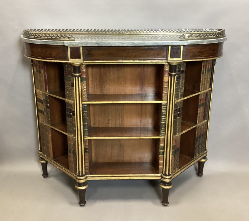 A Regency rosewood breakfront open cabinet featuring a marble top with a brass gallery, central open shelves flanked by faux leather book spines, and fluted gilt columns on tapered legs. View XVII