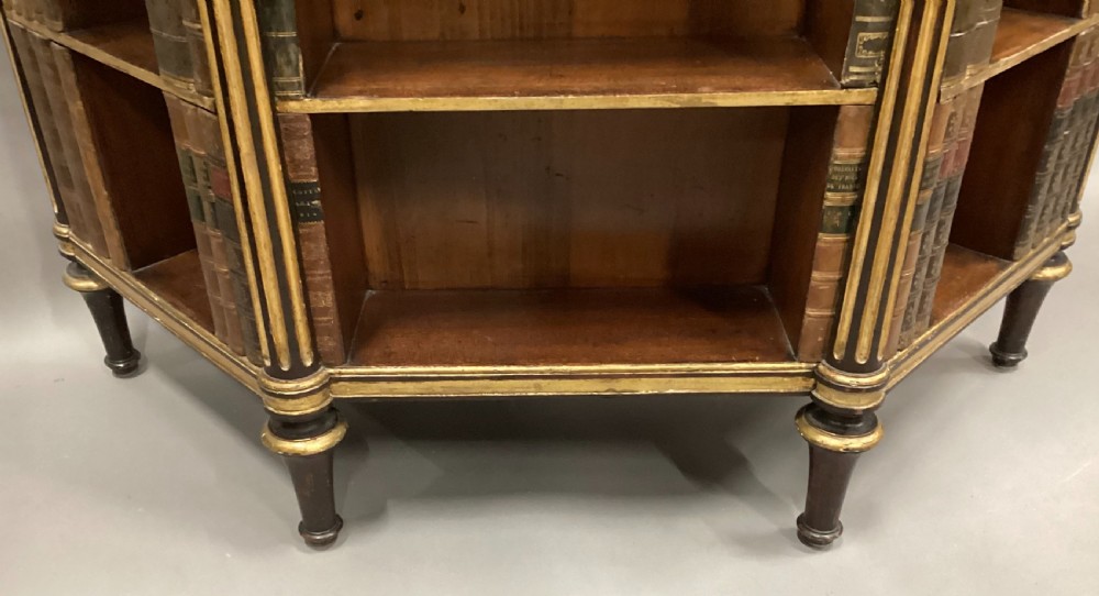 A Regency rosewood breakfront open cabinet featuring a marble top with a brass gallery, central open shelves flanked by faux leather book spines, and fluted gilt columns on tapered legs. View XVIII