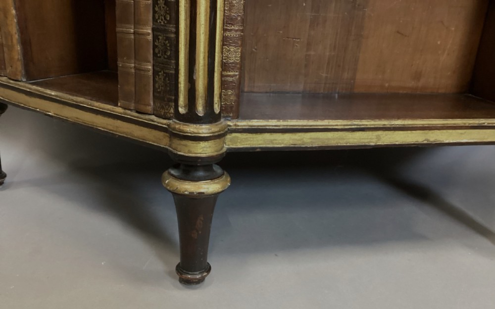 A Regency rosewood breakfront open cabinet featuring a marble top with a brass gallery, central open shelves flanked by faux leather book spines, and fluted gilt columns on tapered legs. View XXI