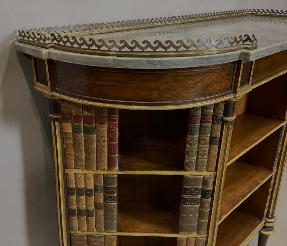 A Regency rosewood breakfront open cabinet featuring a marble top with a brass gallery, central open shelves flanked by faux leather book spines, and fluted gilt columns on tapered legs. View XXIII