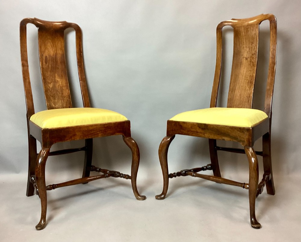 A pair of 18th-century Chinese Huanghuali side chairs featuring curved backsplats and yellow upholstered seats. View II
