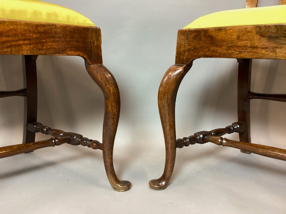 A pair of 18th-century Chinese Huanghuali side chairs featuring curved backsplats and yellow upholstered seats. View VI