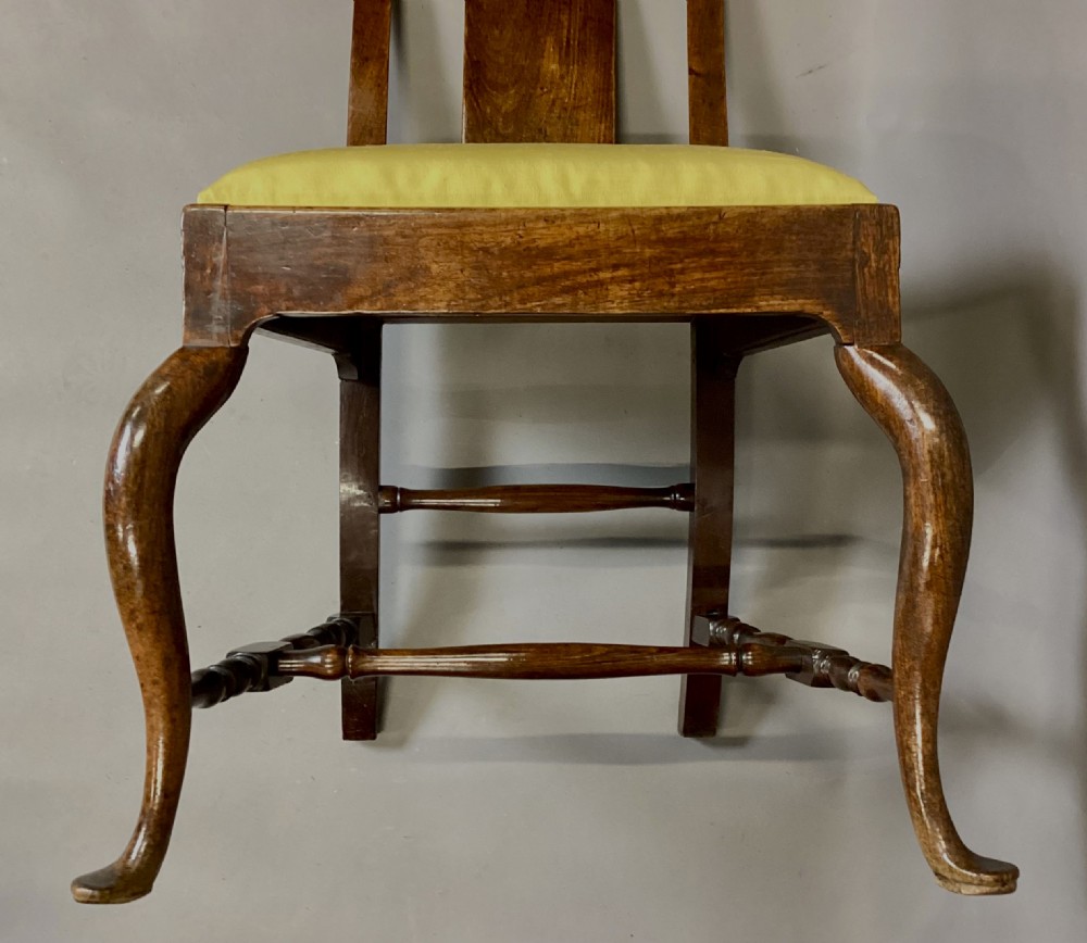 A pair of 18th-century Chinese Huanghuali side chairs featuring curved backsplats and yellow upholstered seats. View VII