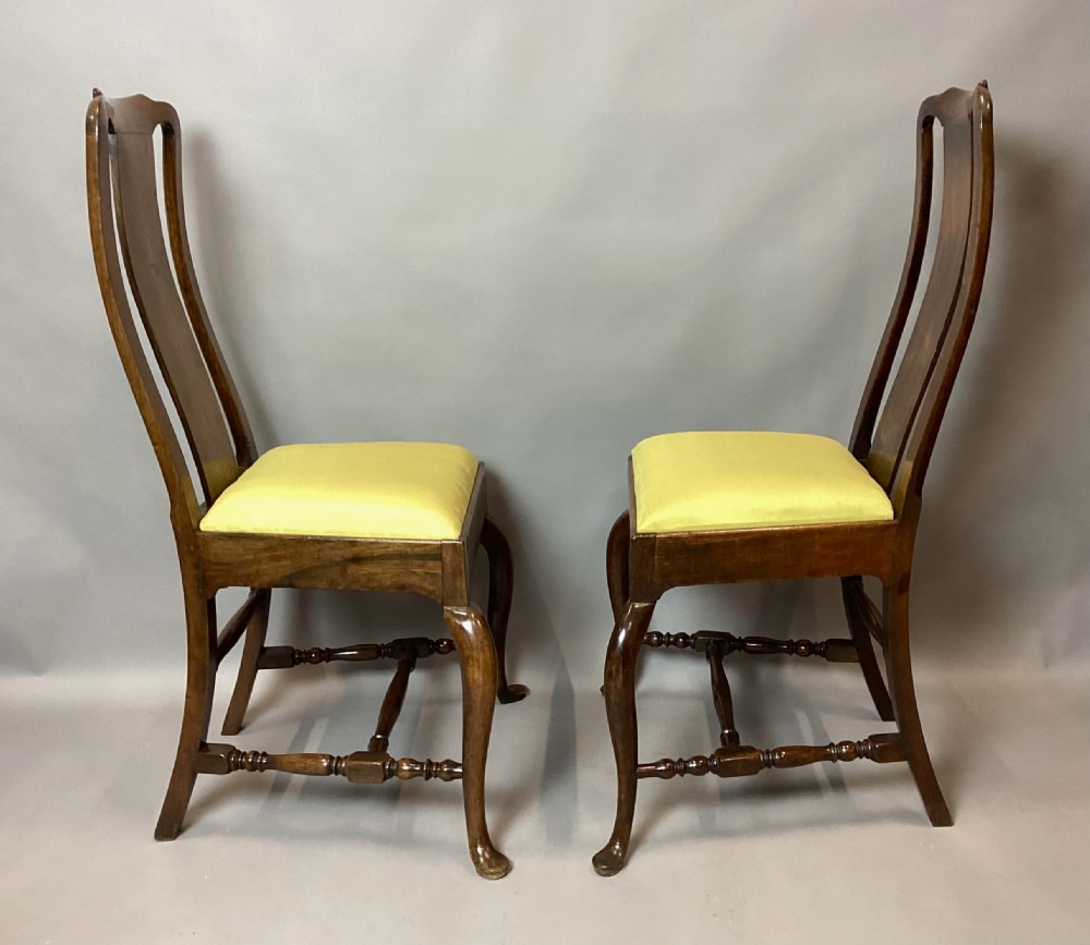 A pair of 18th-century Chinese Huanghuali side chairs featuring curved backsplats and yellow upholstered seats. View VIII