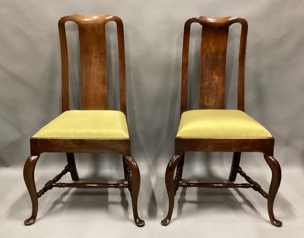 A pair of 18th-century Chinese Huanghuali side chairs featuring curved backsplats and yellow upholstered seats. View XI