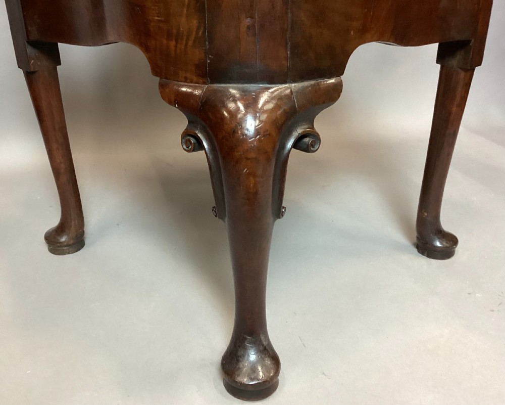 An antique George I walnut corner chair featuring a curved backrest, turned support posts, twin splats, a drop-in seat, and a central cabriole front leg. View III