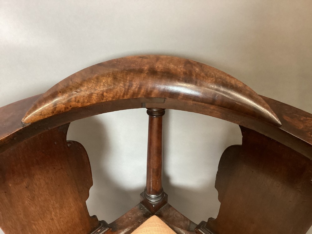 An antique George I walnut corner chair featuring a curved backrest, turned support posts, twin splats, a drop-in seat, and a central cabriole front leg. View VI