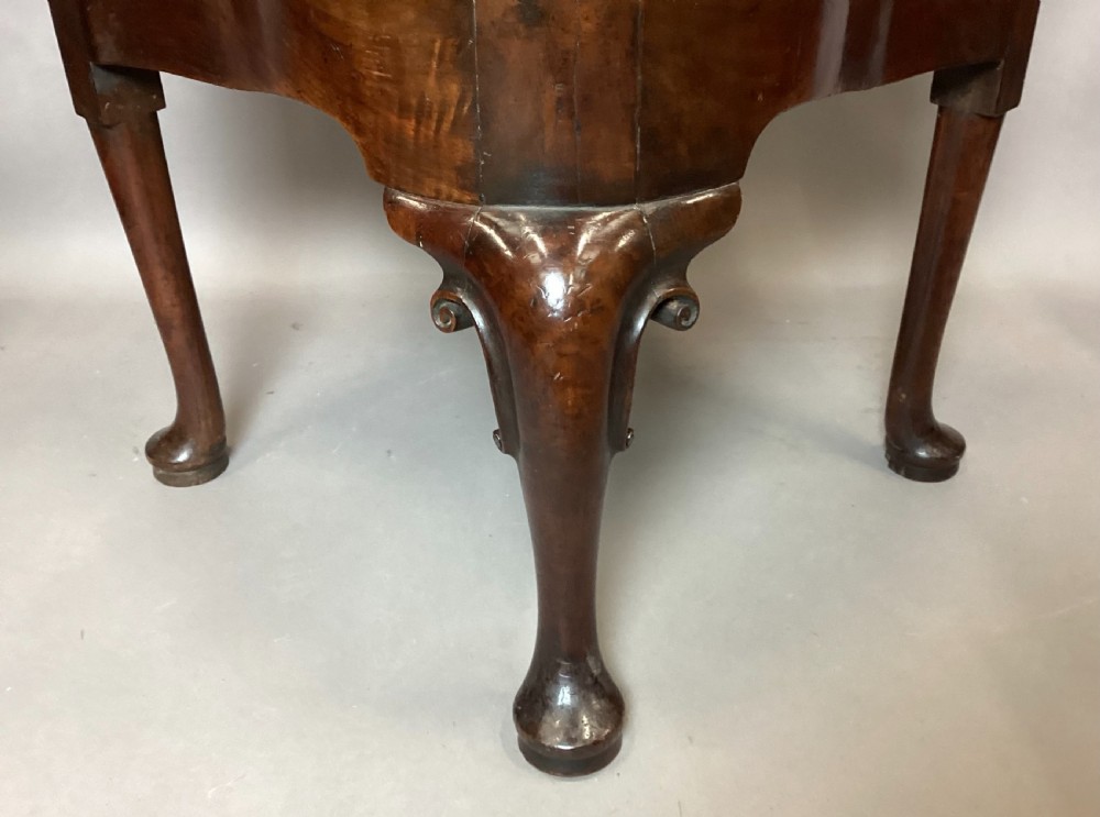 An antique George I walnut corner chair featuring a curved backrest, turned support posts, twin splats, a drop-in seat, and a central cabriole front leg. View XIII