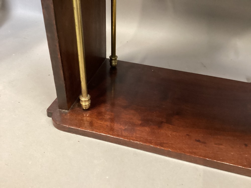 A four-tier Regency mahogany wall shelf unit featuring vertical brass support rods and top brass mounting brackets. View XVI