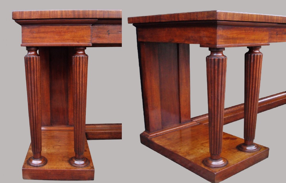A Regency mahogany serving table featuring a polished rectangular top supported by twin reeded columns on plinth bases. View VII