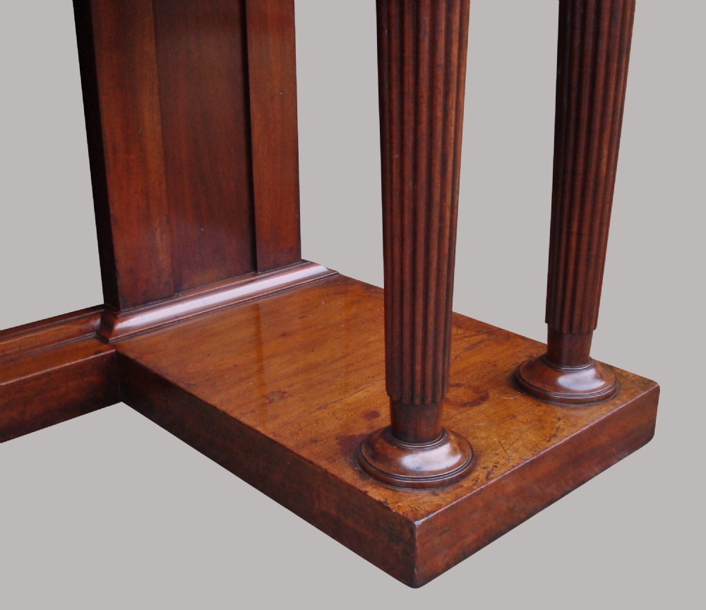 A Regency mahogany serving table featuring a polished rectangular top supported by twin reeded columns on plinth bases. View VIII