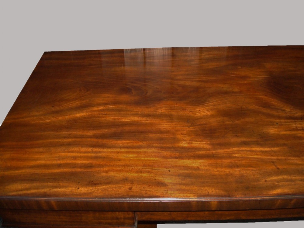 A Regency mahogany serving table featuring a polished rectangular top supported by twin reeded columns on plinth bases. View XIV