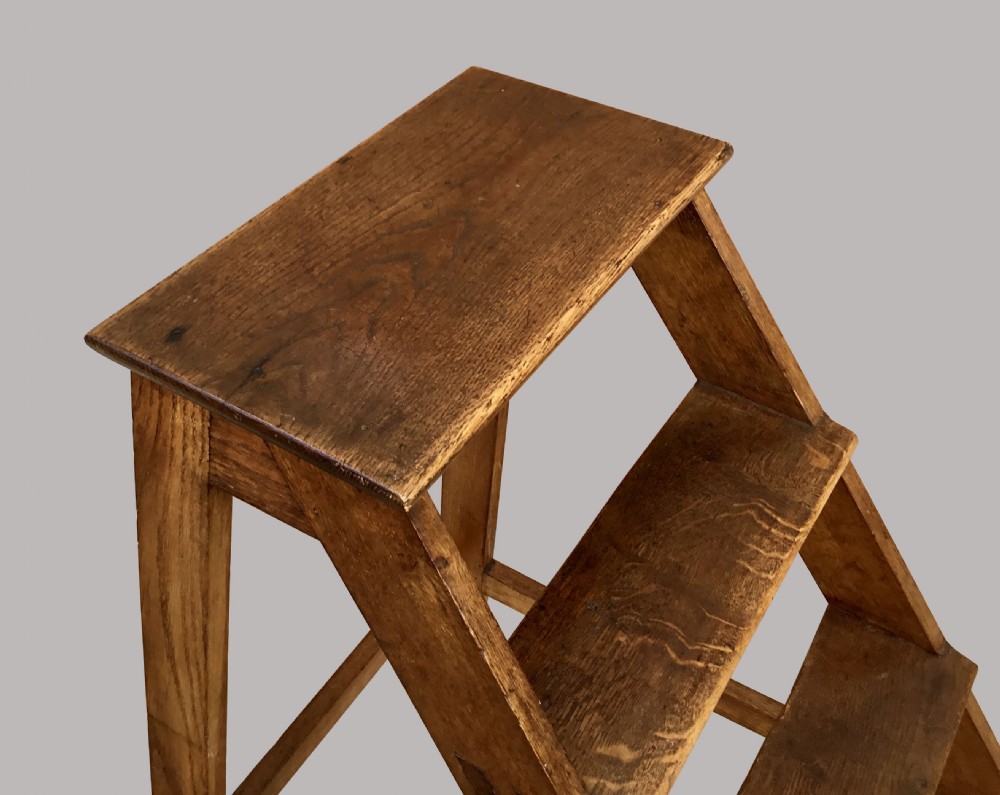 A nineteenth-century dark oak set of library steps featuring four open treads and visible joinery details. View IV