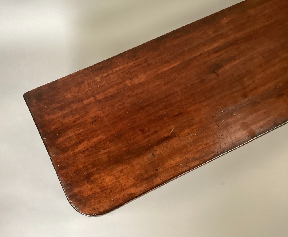 A long Regency mahogany hall bench featuring turned reeded legs, a rectangular solid top with rounded corners, and a polished dark timber finish. View III