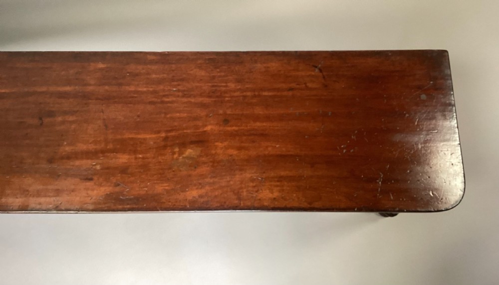 A long Regency mahogany hall bench featuring turned reeded legs, a rectangular solid top with rounded corners, and a polished dark timber finish. View VIII