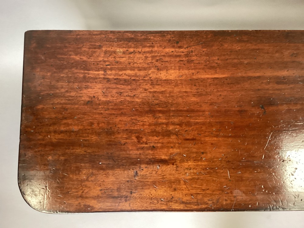 A long Regency mahogany hall bench featuring turned reeded legs, a rectangular solid top with rounded corners, and a polished dark timber finish. View X