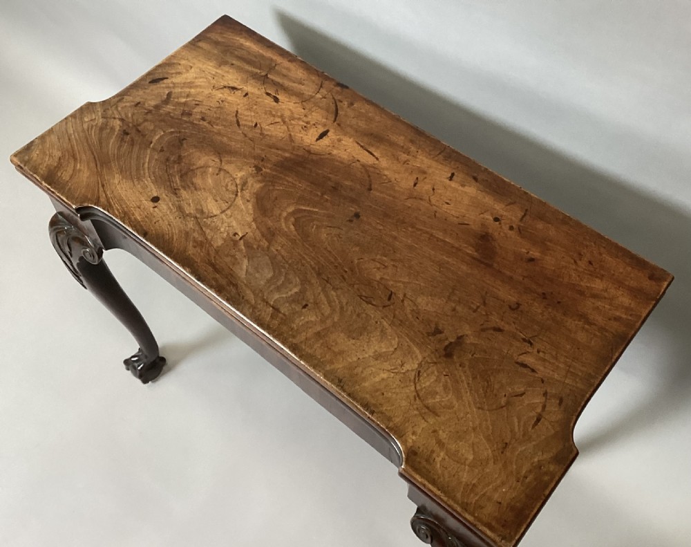 A George II mahogany fold-over tea table featuring carved cabriole legs with acanthus knees and claw-and-ball feet. View III