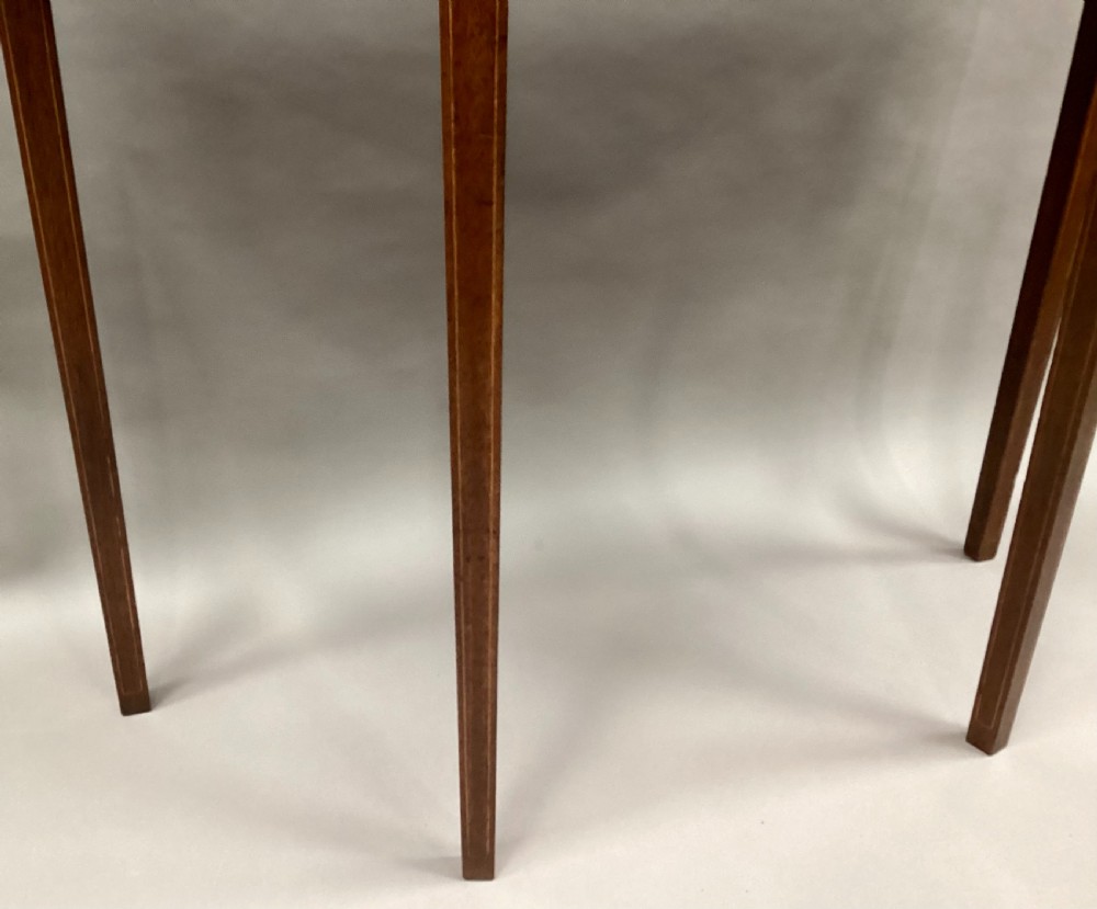 A semi-circular George III style mahogany console table featuring subtle line inlay and four slender square tapered legs. View XV