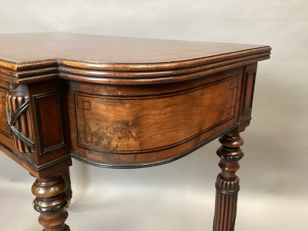 A Regency mahogany side table featuring ebony inlay details, turned spiral legs with brass castors, and a front drawer with circular brass handles. View XIV