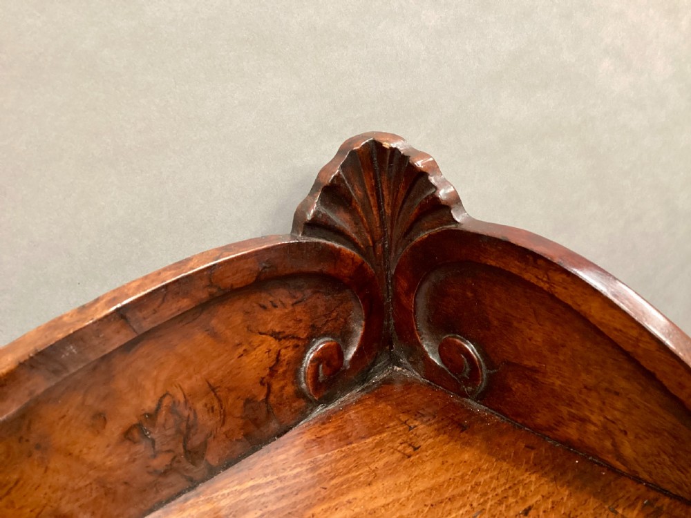 A Regency period side cabinet crafted from figured pollard oak featuring two panelled doors, a carved anthemion upstand, and a plinth base. View XV
