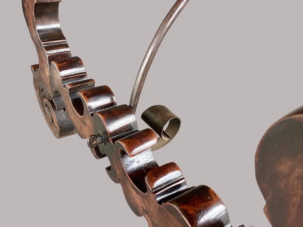 An 18th-century Spanish walnut and fruitwood centre table featuring carved trestle supports, decorative edge moulding, and wrought iron stretchers. View VIII
