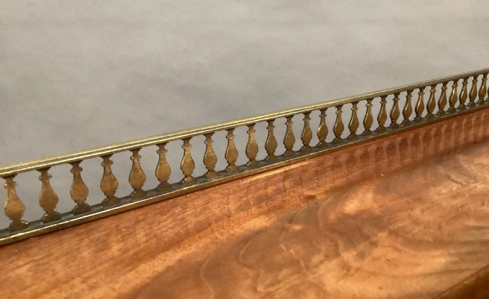 A Regency figured mahogany side cabinet with a top mirror shelf supported by brass spiral columns and topped with a brass gallery. View XIX