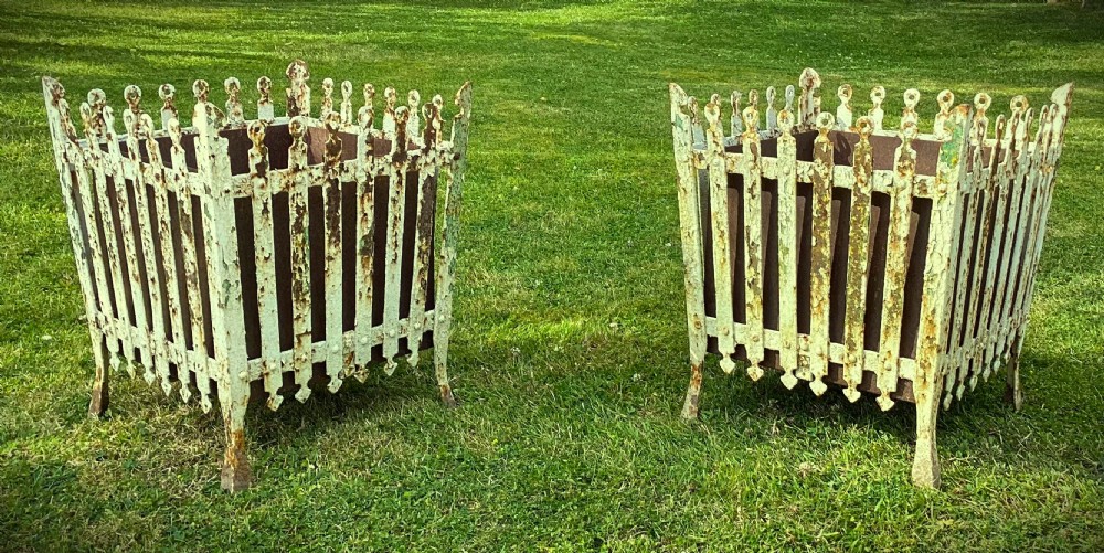 A pair of square 19th-century wrought iron strapwork planters with distressed cream paint, finial borders, and solid metal liners.