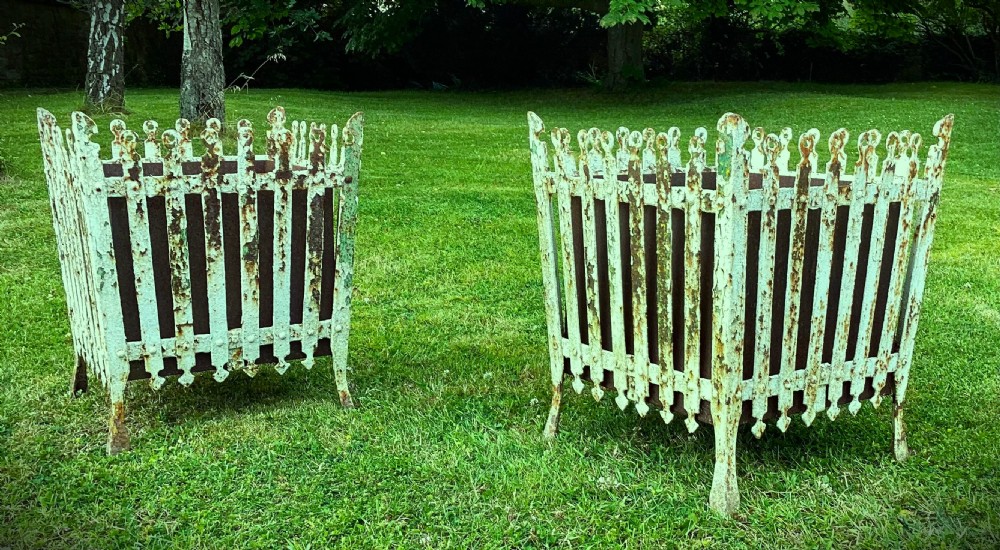 A pair of square 19th-century wrought iron strapwork planters with distressed cream paint, finial borders, and solid metal liners. View IX