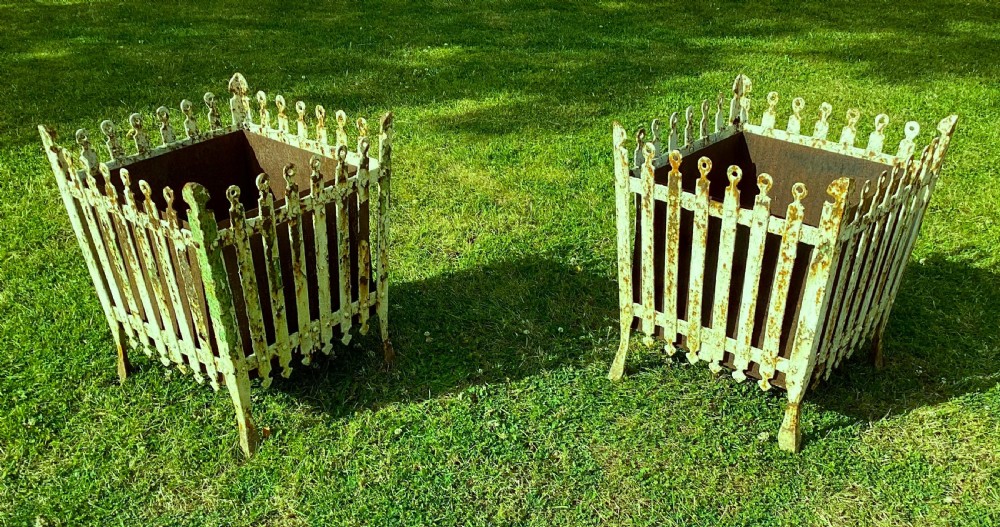 A pair of square 19th-century wrought iron strapwork planters with distressed cream paint, finial borders, and solid metal liners. View XII