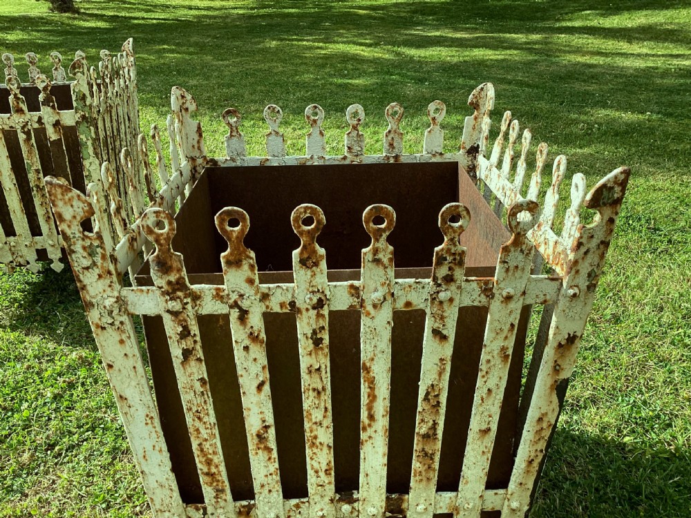 A pair of square 19th-century wrought iron strapwork planters with distressed cream paint, finial borders, and solid metal liners. View XIII
