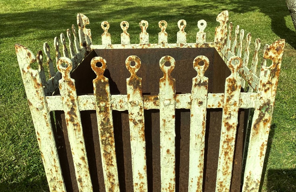 A pair of square 19th-century wrought iron strapwork planters with distressed cream paint, finial borders, and solid metal liners. View XIV