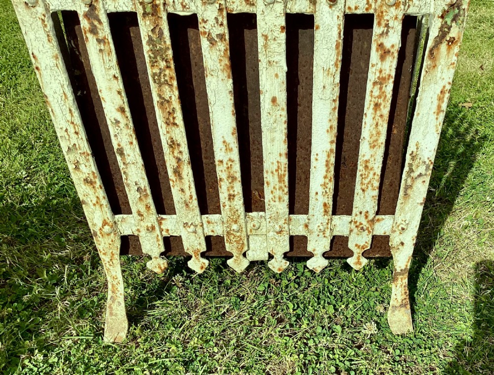 A pair of square 19th-century wrought iron strapwork planters with distressed cream paint, finial borders, and solid metal liners. View XVII